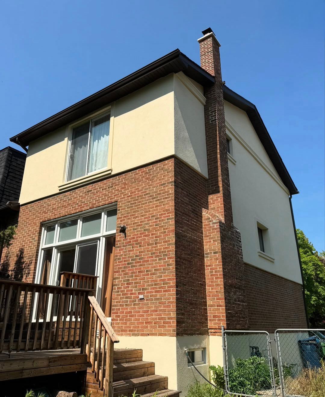 Home exterior with stucco upper and brick lower section